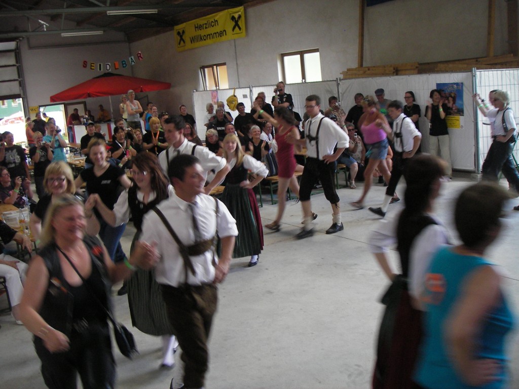 Local youngsters teach the WIMAs traditional dancing
