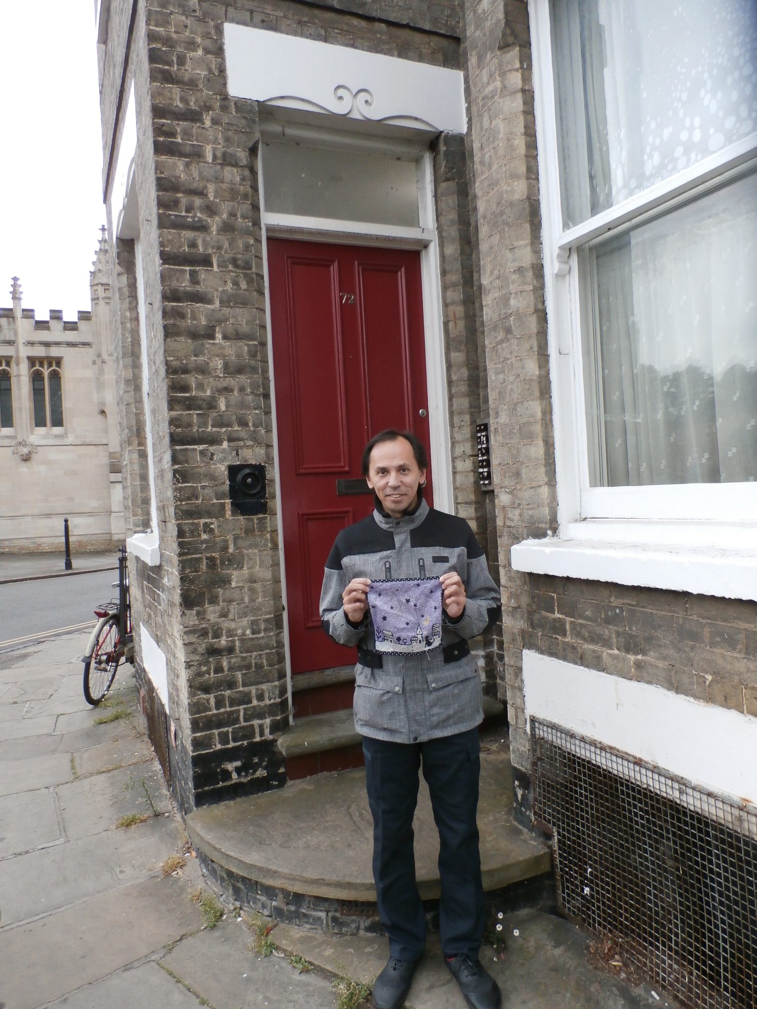 Christopher with his Japanese hand towel outside 72 Jesus Lane where Douglas Adams lived his first years